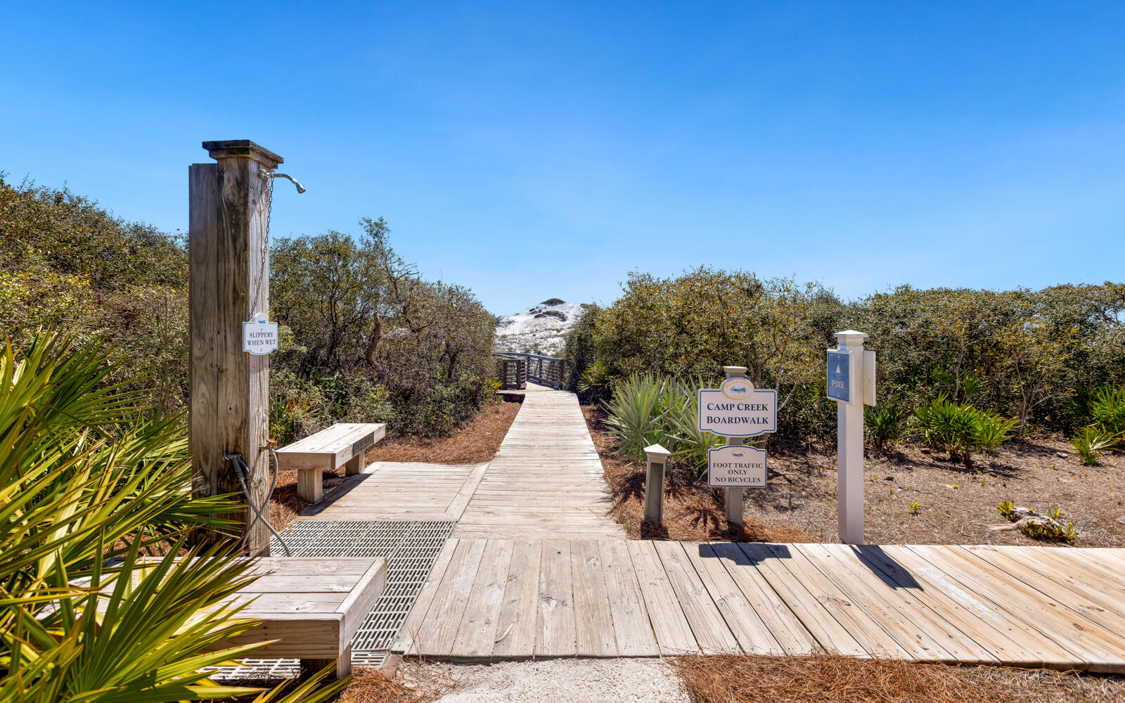 100 Bridge Lane, Unit 214C Inlet Beach, FL 32461 - Photo 37 of 54 a view of a patio with table and chairs with wooden floor and fence