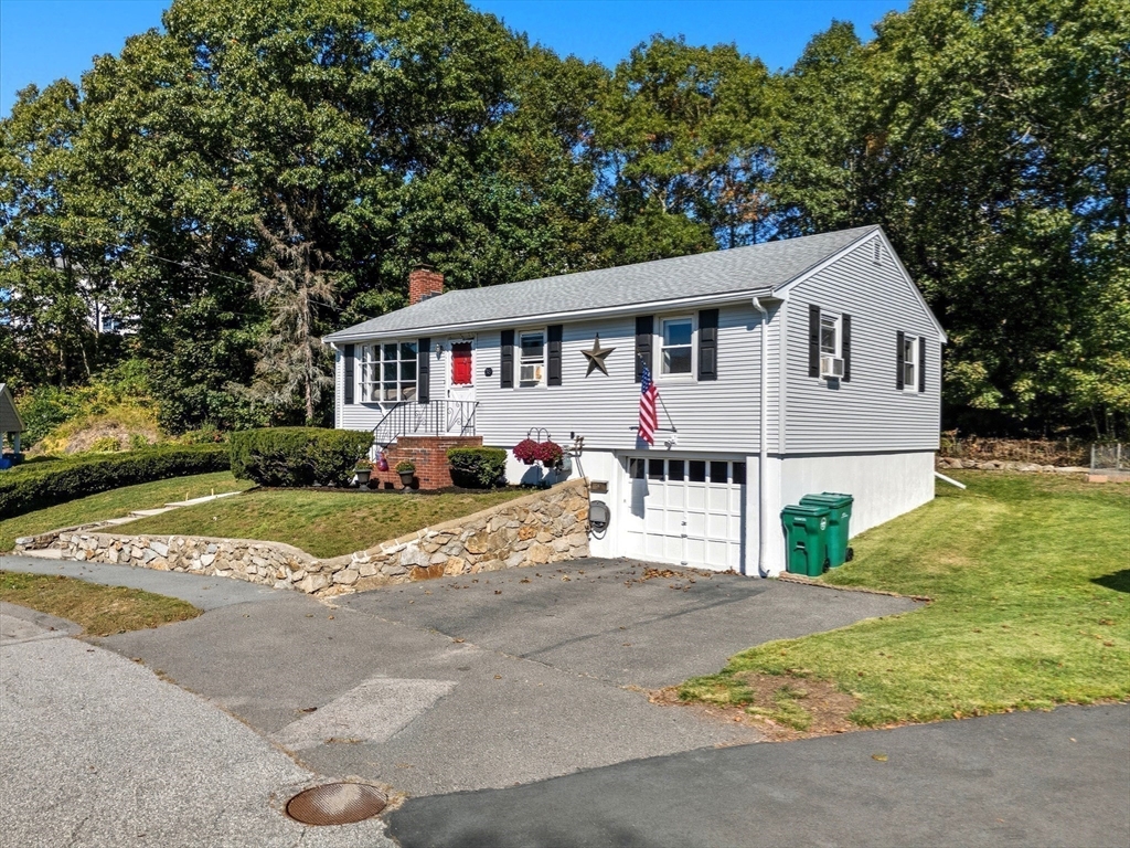 35 Oak Ridge Circle Lynn, MA 01904 - Photo 2 of 37 a front view of a house with a garden and trees