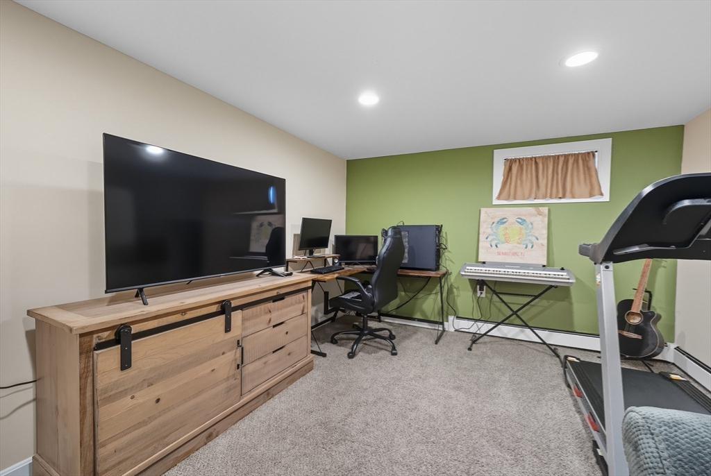 35 Oak Ridge Circle Lynn, MA 01904 - Photo 26 of 37 a room with furniture and a flat screen tv