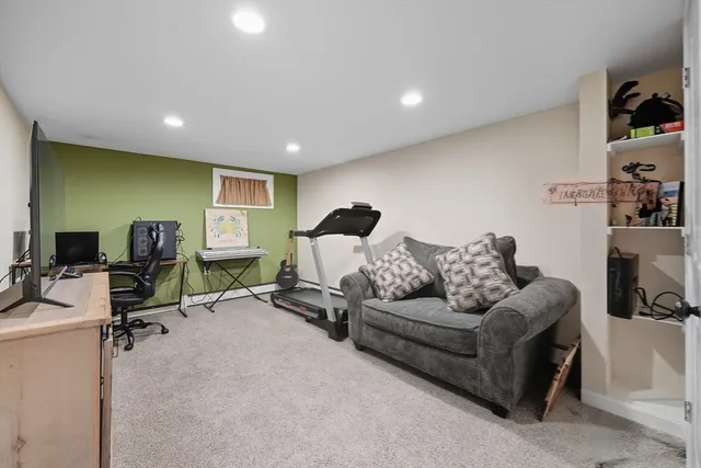 a living room with furniture gym equipment and a flat screen tv