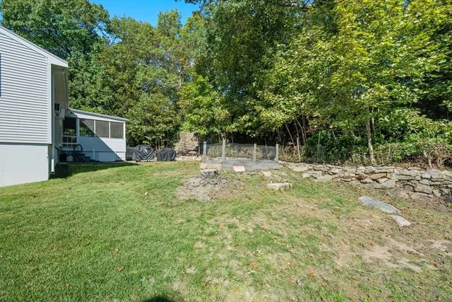 a backyard of a house with table and chairs