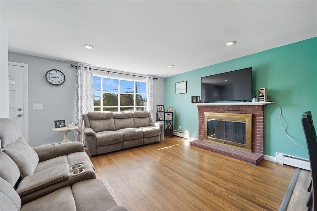 35 Oak Ridge Circle Lynn, MA 01904 - Photo 9 of 37 a living room with furniture a flat screen tv and a fireplace