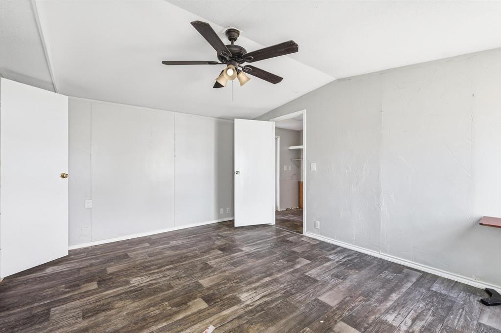 316 Summit Drive Springtown, TX 76082 - Photo 11 of 39 This room features durable plank flooring, light-colored walls, and a ceiling fan with integrated lighting