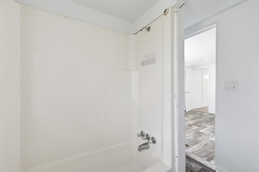 316 Summit Drive Springtown, TX 76082 - Photo 16 of 39 Bathroom featuring a white bathtub and shower surround with chrome fixtures, and white walls