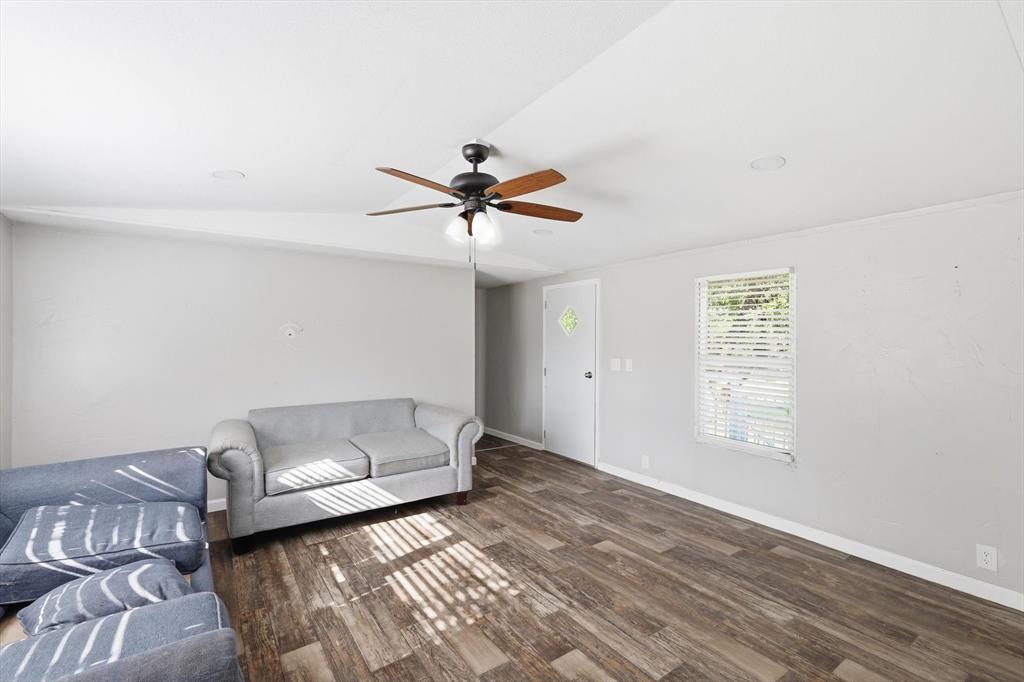 316 Summit Drive Springtown, TX 76082 - Photo 17 of 39 Living area featuring wood-style flooring, a ceiling fan with light, and a window with blinds