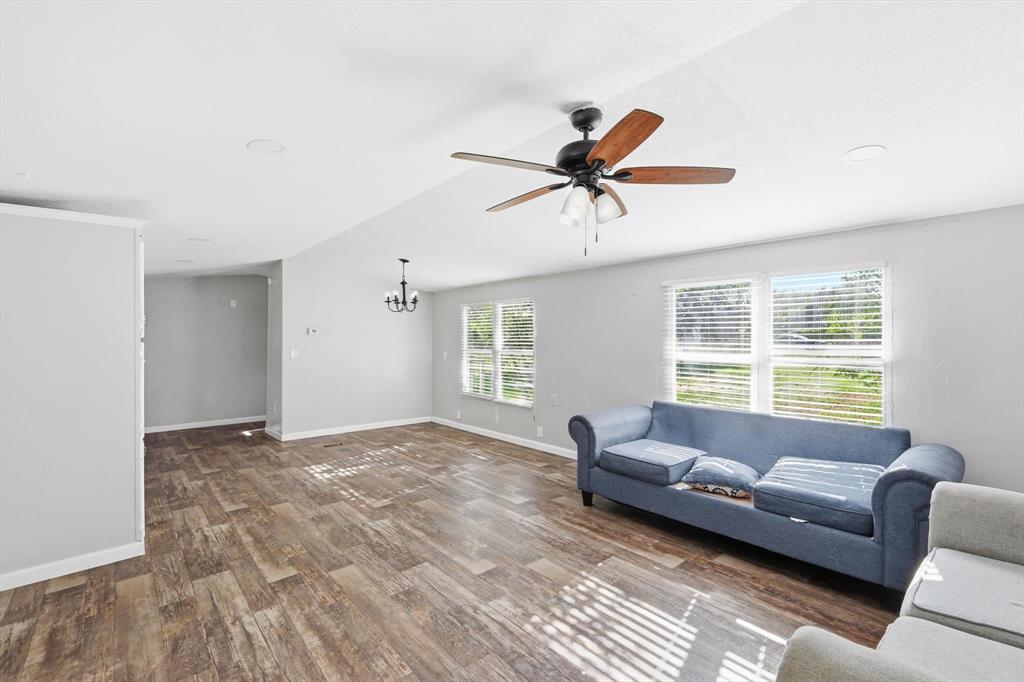316 Summit Drive Springtown, TX 76082 - Photo 18 of 39 Spacious interior with durable flooring, a ceiling fan, and ample natural light from multiple windows