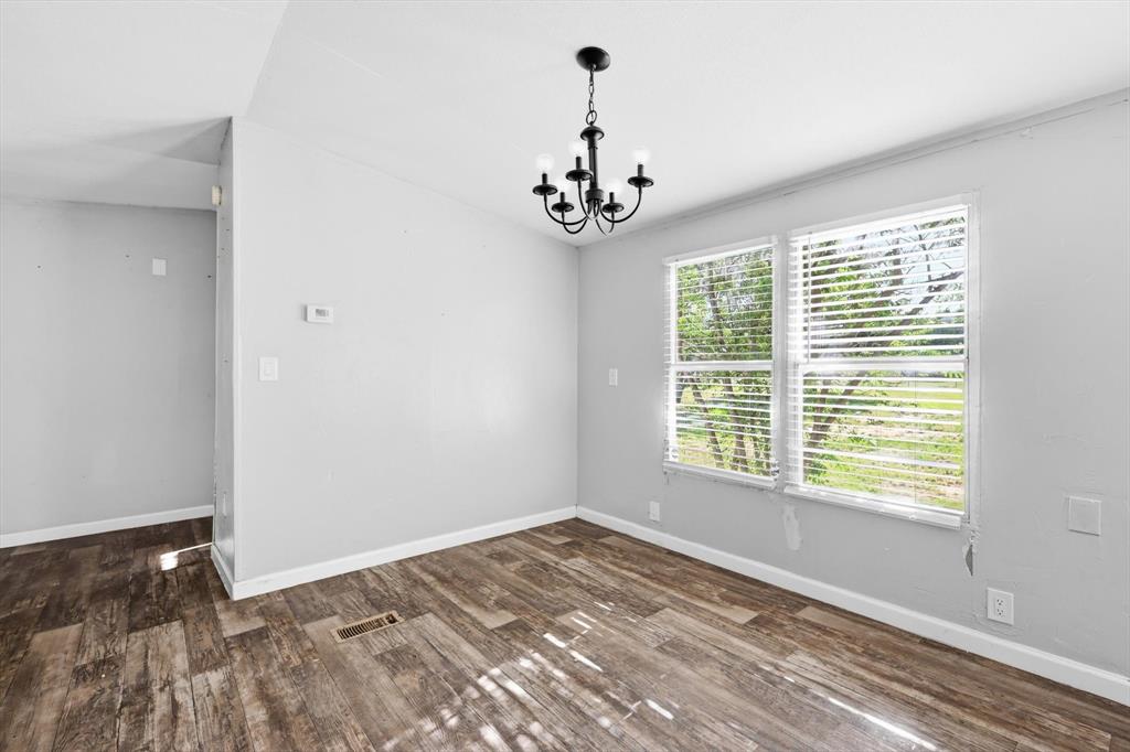 316 Summit Drive Springtown, TX 76082 - Photo 19 of 39 This room features durable plank flooring, light-colored walls, and a ceiling-mounted light fixture