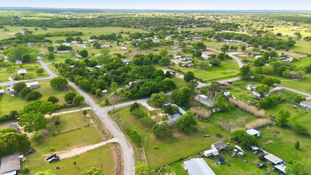 316 Summit Drive Springtown, TX 76082 - Photo 36 of 39 Aerial view of the community, featuring residential properties amidst expansive green spaces and mature trees