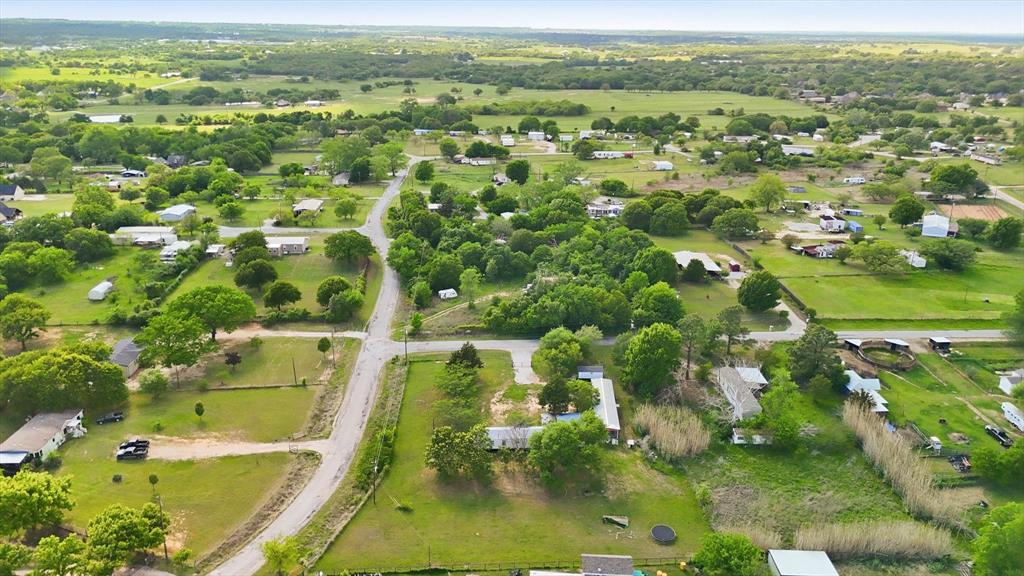 316 Summit Drive Springtown, TX 76082 - Photo 37 of 39 Aerial view showcasing expansive green landscapes, interspersed with mature trees and residential properties