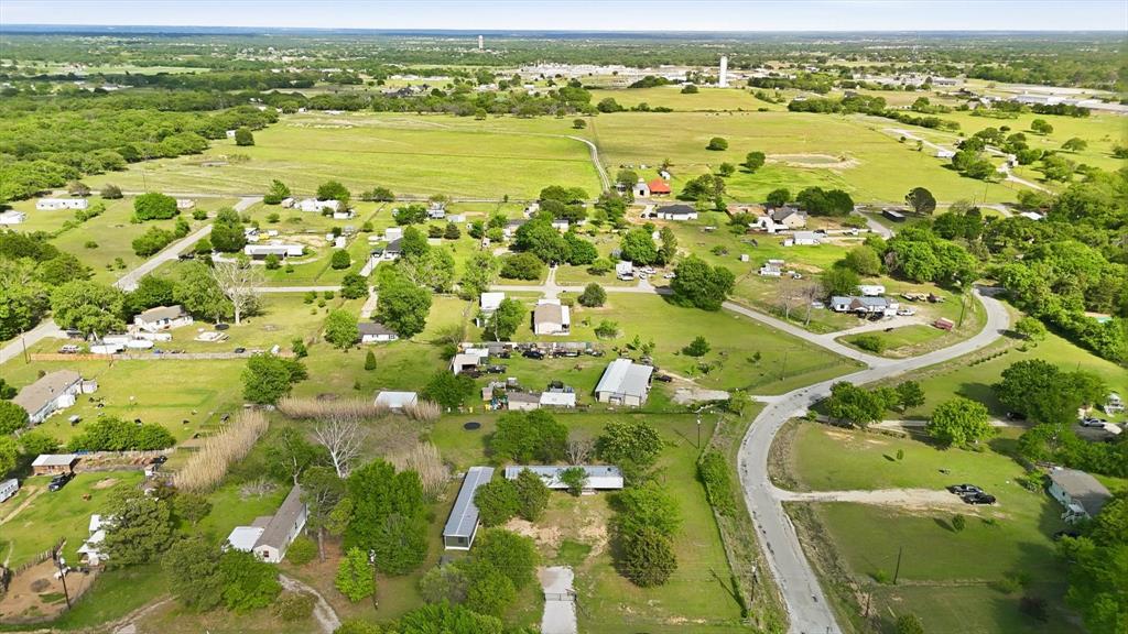 316 Summit Drive Springtown, TX 76082 - Photo 38 of 39 Expansive aerial view showcasing a landscape with green fields and scattered homes, featuring winding roads and mature trees