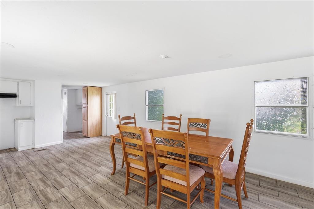 316 Summit Drive Springtown, TX 76082 - Photo 8 of 39 The property features an open living space with light-toned tiled flooring, white walls, and white ceilings