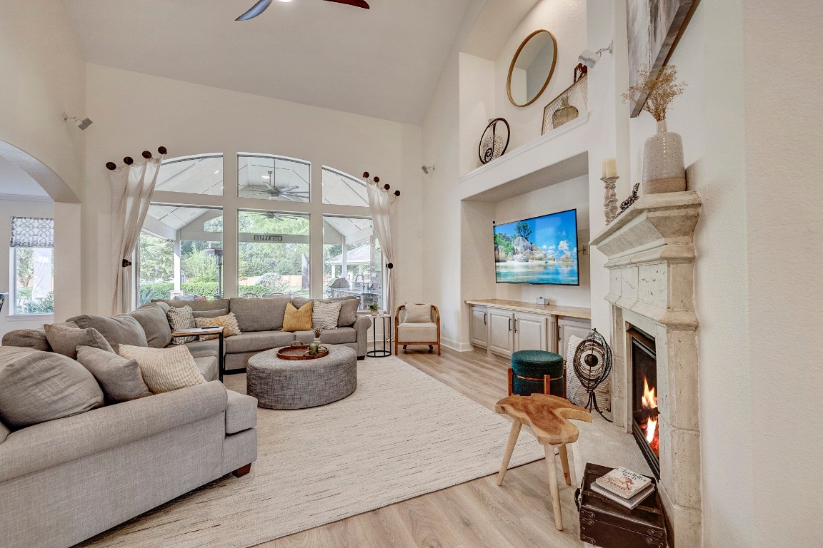 2600 Silverstone Way Conroe, TX 77304 - Photo 11 of 49 a living room with furniture a fireplace and a large window