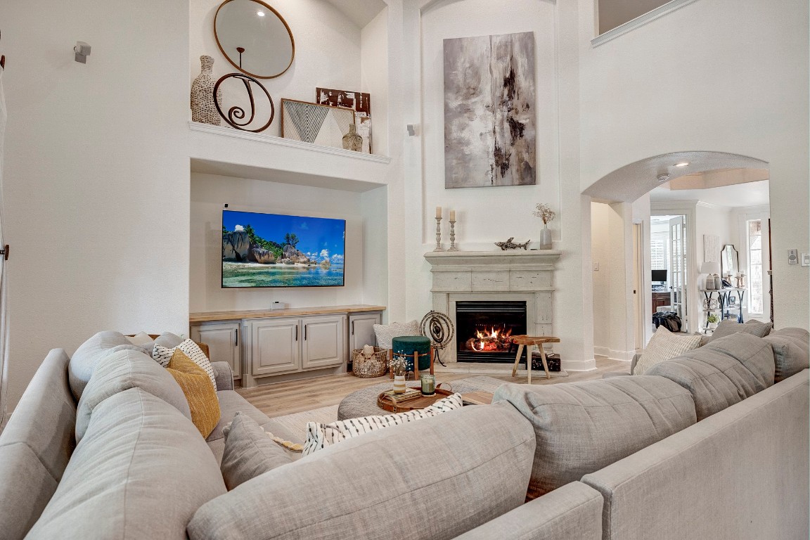 2600 Silverstone Way Conroe, TX 77304 - Photo 13 of 49 a living room with furniture a flat screen tv and a fireplace
