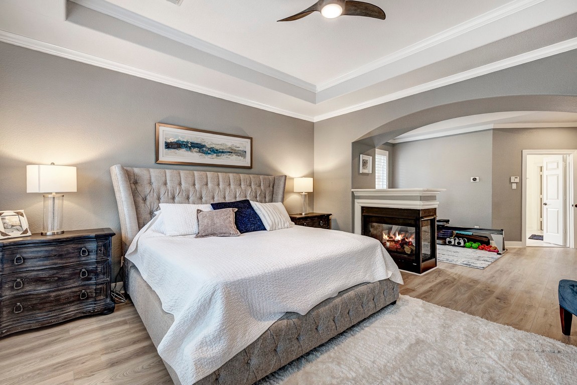 2600 Silverstone Way Conroe, TX 77304 - Photo 20 of 49 a spacious bedroom with a bed and a fireplace