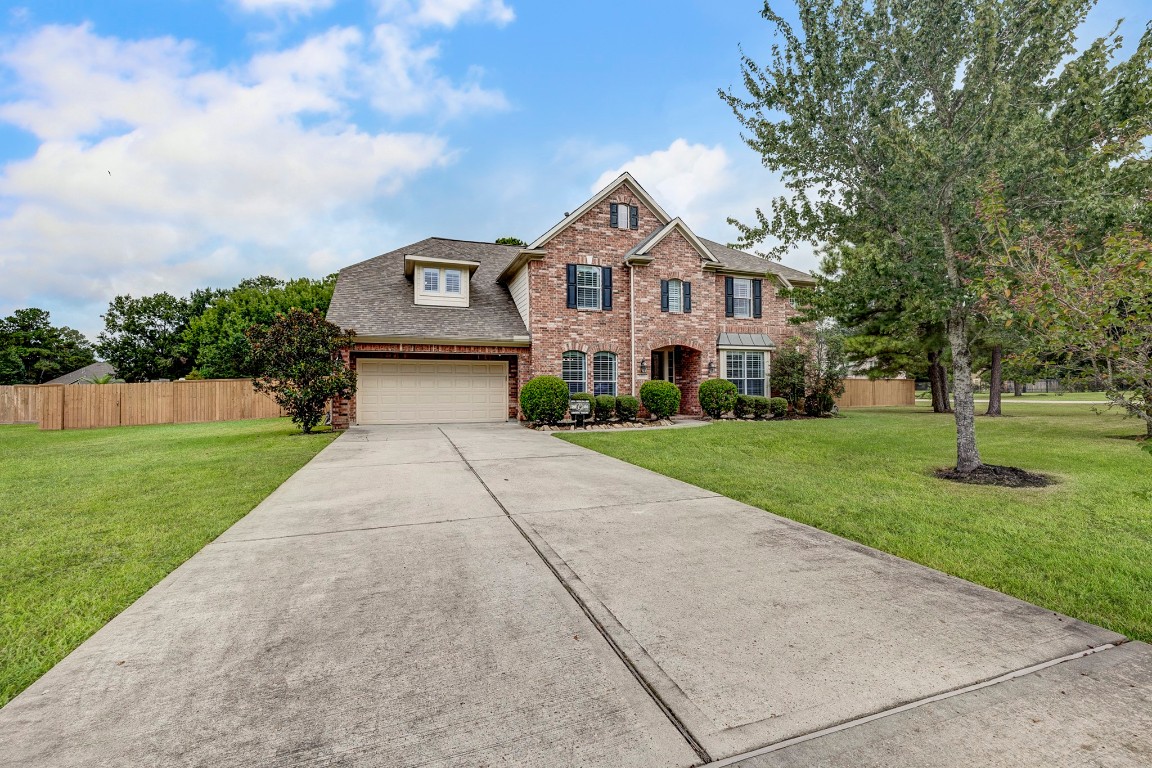 2600 Silverstone Way Conroe, TX 77304 - Photo 2 of 49 a front view of a house with a yard