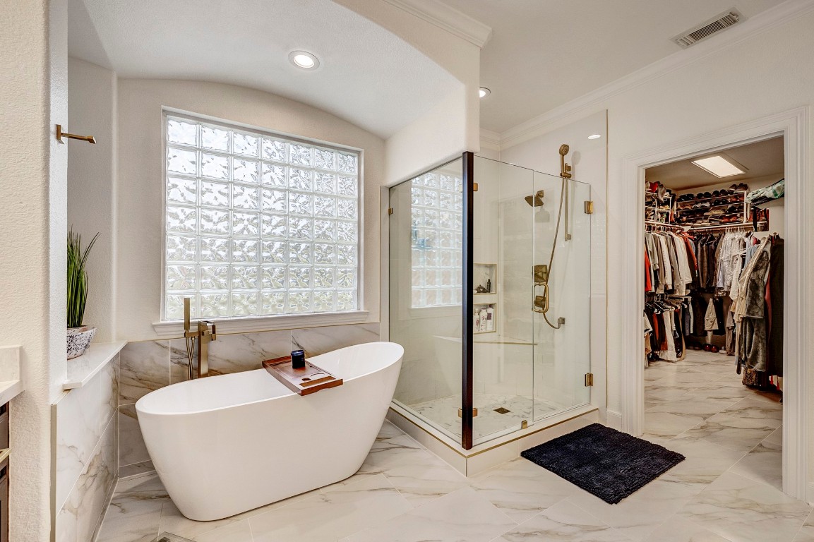 2600 Silverstone Way Conroe, TX 77304 - Photo 24 of 49 Complemented by a spa-inspired bath featuring dual vanities, soaking tub, and a spacious walk-in shower.