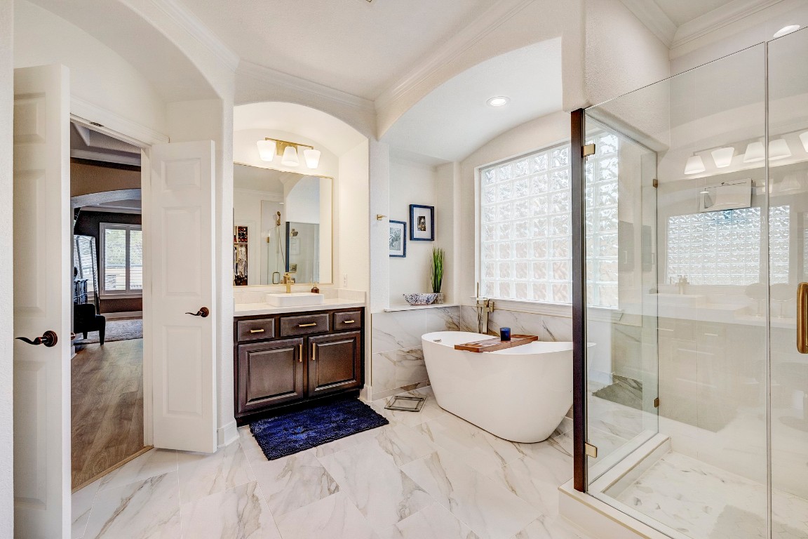 2600 Silverstone Way Conroe, TX 77304 - Photo 25 of 49 a spacious bathroom with a double vanity sink a mirror and a shower