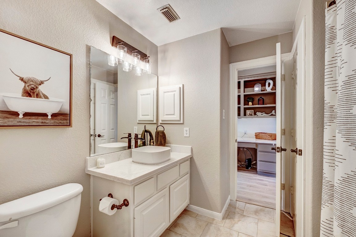 2600 Silverstone Way Conroe, TX 77304 - Photo 26 of 49 a bathroom with a sink a toilet and a mirror