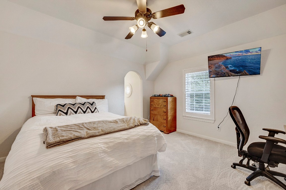 2600 Silverstone Way Conroe, TX 77304 - Photo 28 of 49 a bedroom with a bed a desk and chair