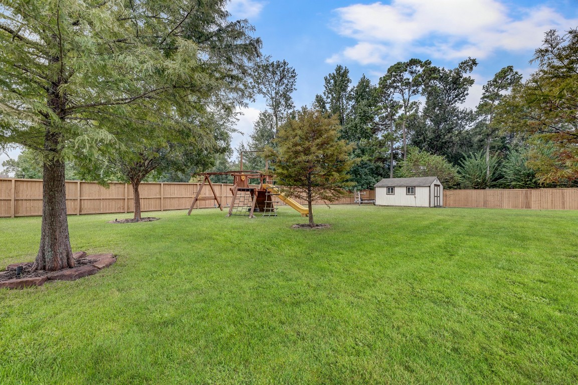 2600 Silverstone Way Conroe, TX 77304 - Photo 44 of 49 a view of a park with a bench and trees