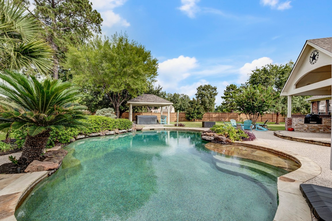 2600 Silverstone Way Conroe, TX 77304 - Photo 45 of 49 a view of a swimming pool with lounge chairs in patio