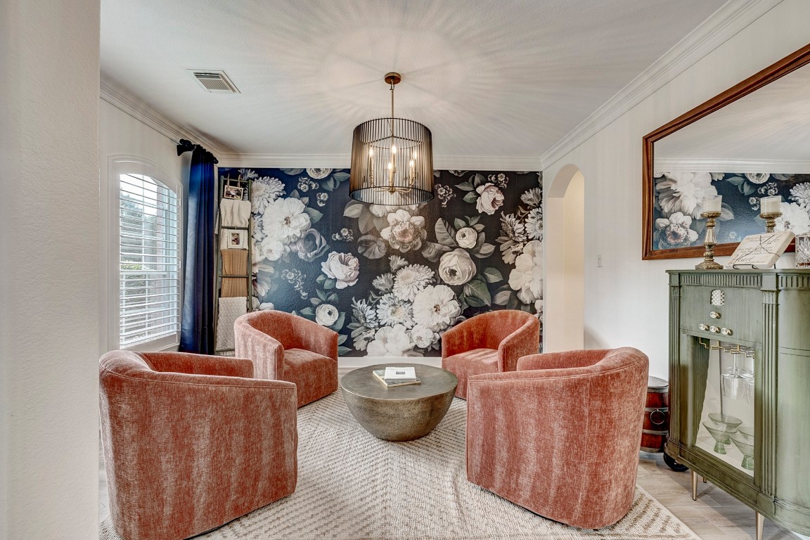 2600 Silverstone Way Conroe, TX 77304 - Photo 5 of 49 a living room with furniture a fireplace and a chandelier