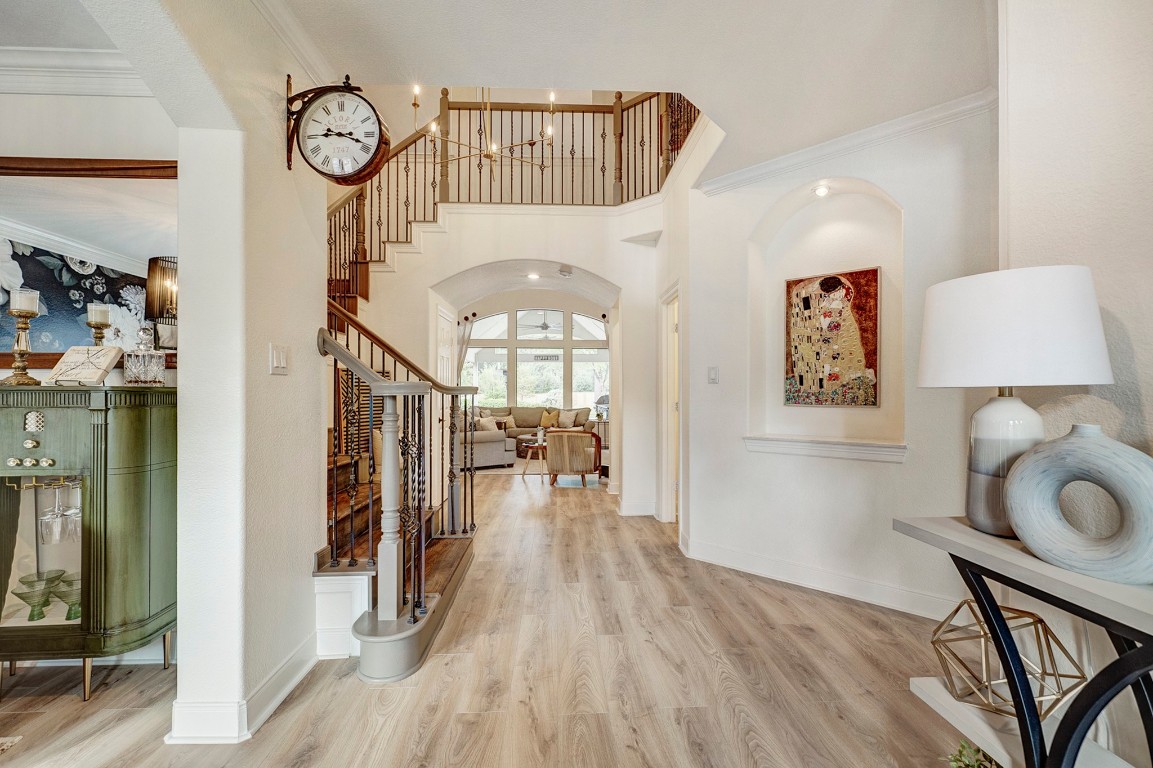 2600 Silverstone Way Conroe, TX 77304 - Photo 8 of 49 An unforgettable welcome. Soaring ceilings and a dramatic staircase set the tone for sophisticated living, while natural light pours in to highlight the home’s architectural detail.