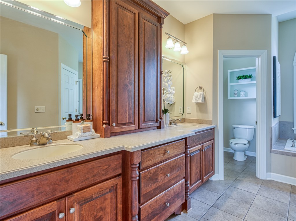 7914 O Neil Road Gloucester, VA 23061 - Photo 20 of 47 Full bath with light tile patterned floors, double vanity, and a garden tub