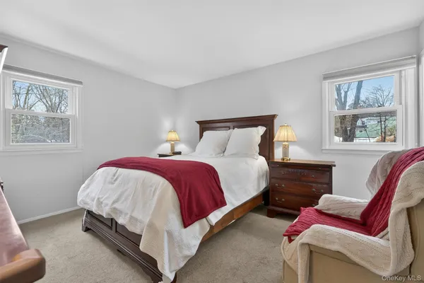 a spacious bedroom with a bed and a couch