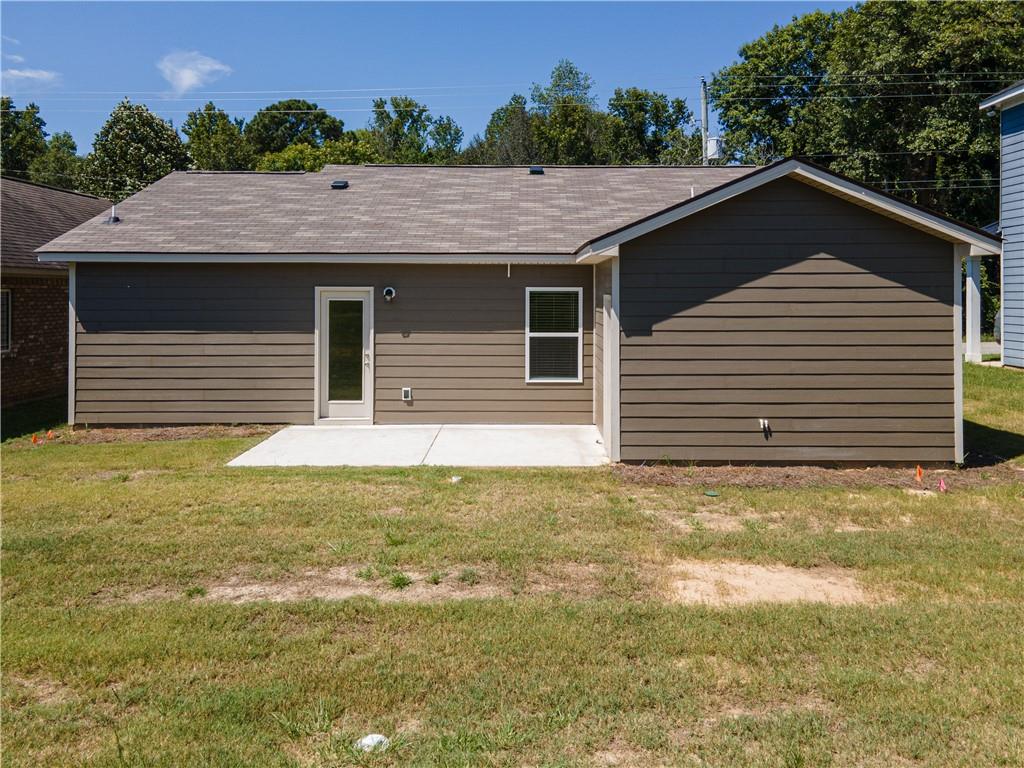 31 Whiterock Road Phenix City, AL 36869 - Photo 20 of 36 Rear view of property featuring a yard, a patio, and a shingled roof