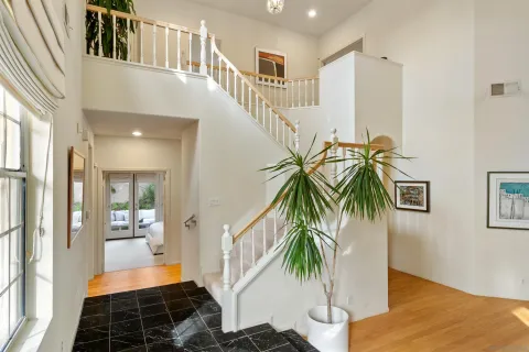 a kitchen with stainless steel appliances granite countertop a refrigerator a stove and a sink with cabinets