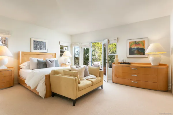 a bedroom with a bed and a mirror