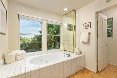 a bedroom with a bed and a large window