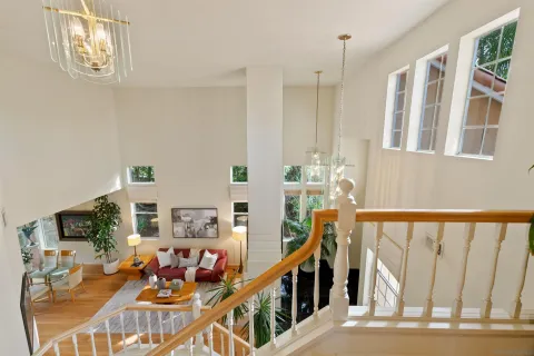 a view of a hallway with furniture and refrigerator