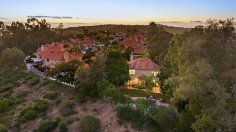 an aerial view of mountain with yard