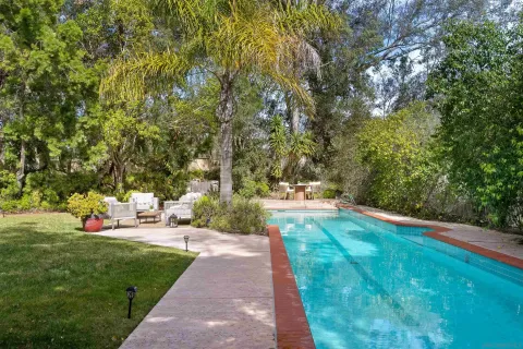 a view of a patio with couches table and chairs and potted plants