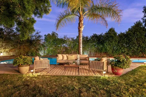 a view of a chairs and table in patio