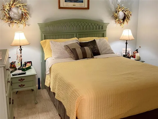 a bed room with a bed and a lamp