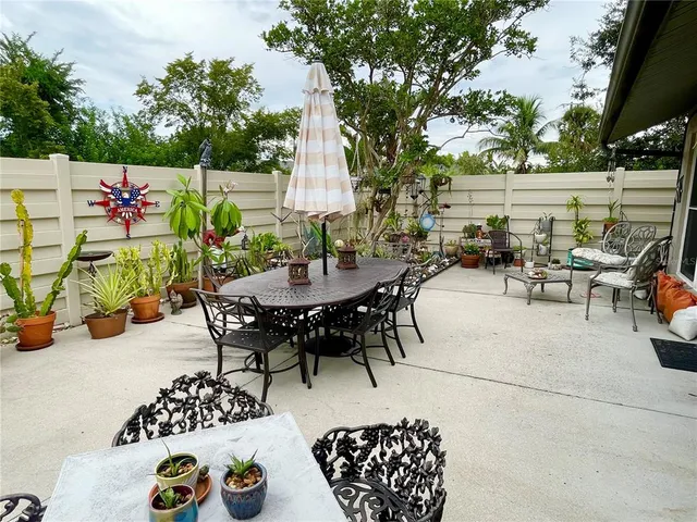 a view of outdoor dining space with furniture and garden