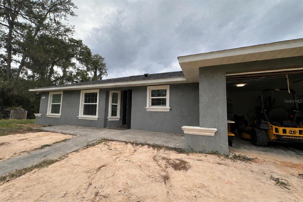 6800 Northeast 175th Street Road Citra, FL 32113 - Photo 3 of 27 a backyard of a house with yard and seating space