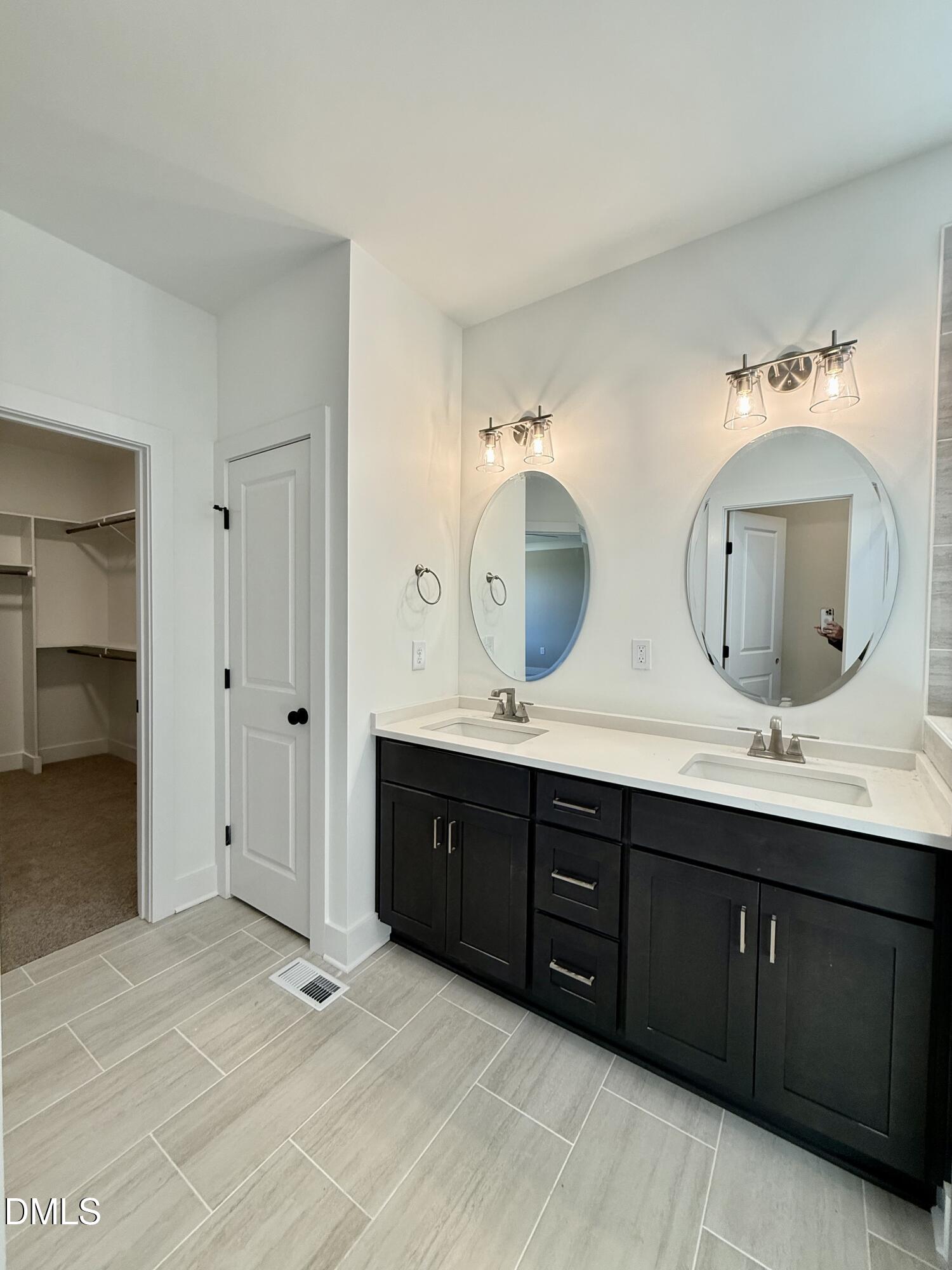 5549 River Buck Rd Spring Spring Hope, NC 27882 - Photo 24 of 35 a spacious bathroom with double vanity and mirrors