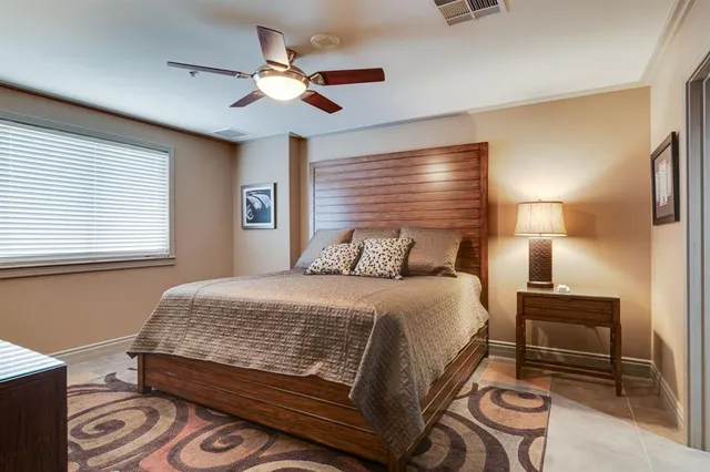 a bedroom with a large bed and a chandelier