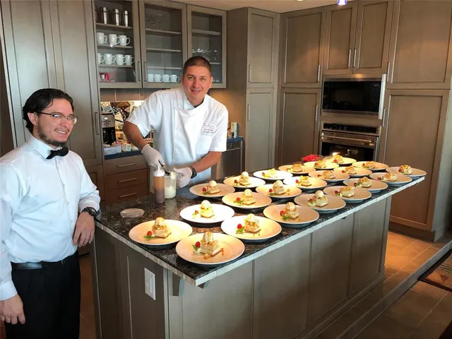 a living room with furniture chandelier and a large window