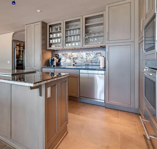 a kitchen with stainless steel appliances granite countertop a refrigerator and a sink