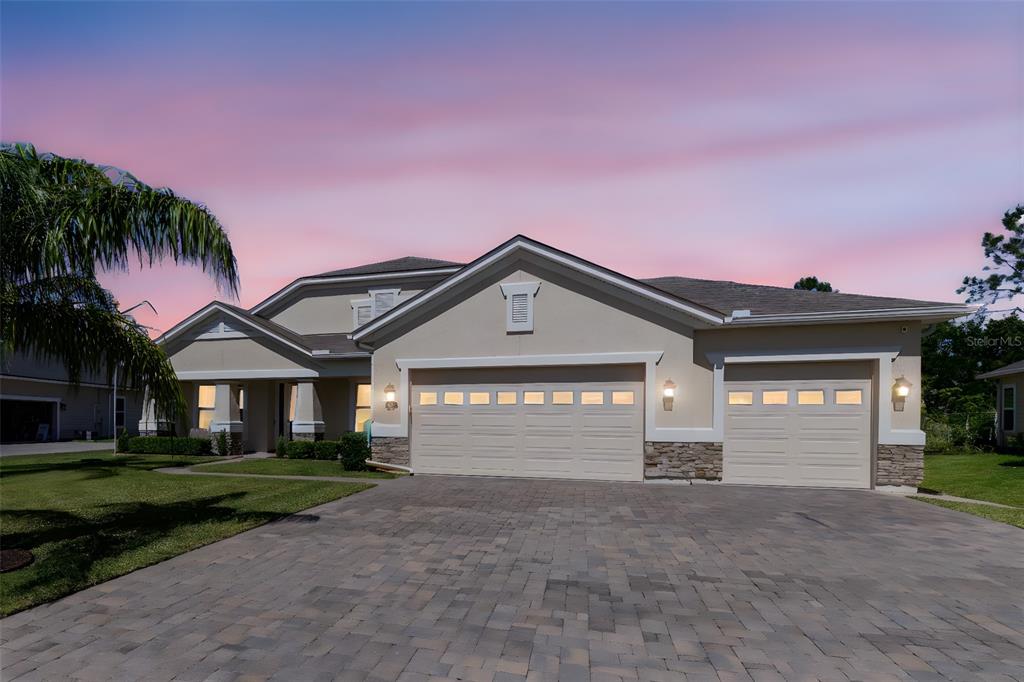 214 Ashford Lakes Circle Ormond Beach, FL 32174 - Photo 1 of 1 a front view of a house with a yard and garage