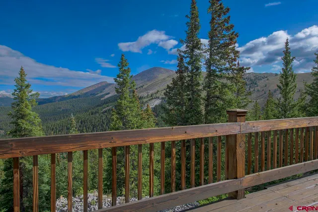 a view of a balcony with wooden fence