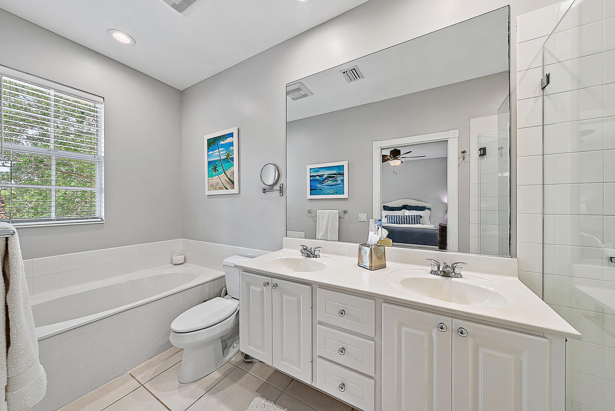 107 Rivinia Drive Jupiter, FL 33458 - Photo 9 of 28 a bathroom with a granite countertop sink mirror bathtub and toilet