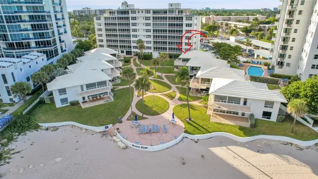 an aerial view of a house with a yard and lake view
