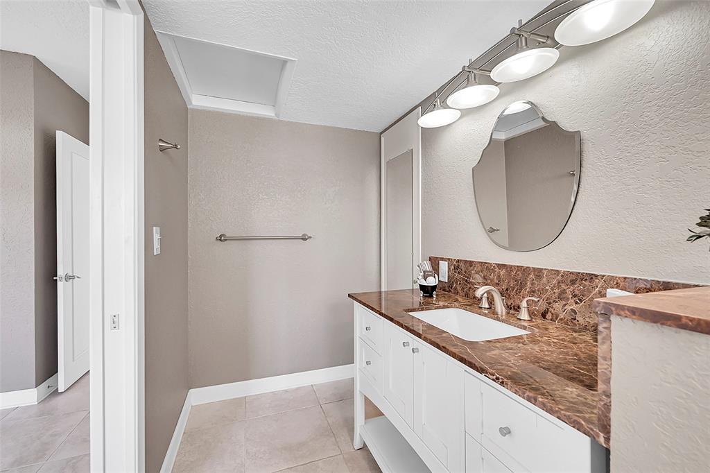 1530 South Ocean Boulevard, Unit 12 Lauderdale-by-the-Sea, FL 33062 - Photo 19 of 81 a bathroom with a sink vanity and a mirror