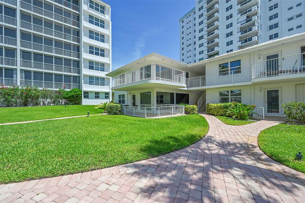 1530 South Ocean Boulevard, Unit 12 Lauderdale-by-the-Sea, FL 33062 - Photo 2 of 81 a view of an apartment with a garden